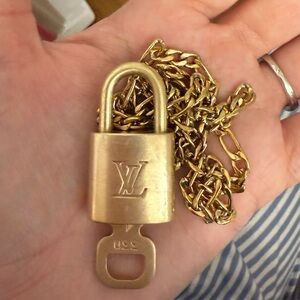 Authentic LV lock and key with a chain.